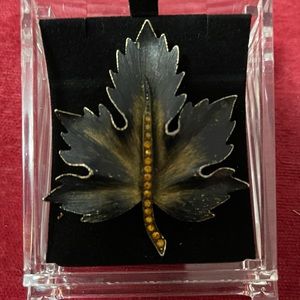 Mid century maple leaf brooch. Gold tone with amber rhinestones in center.